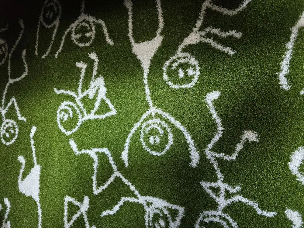 White line-art doodles stitched into green play turf