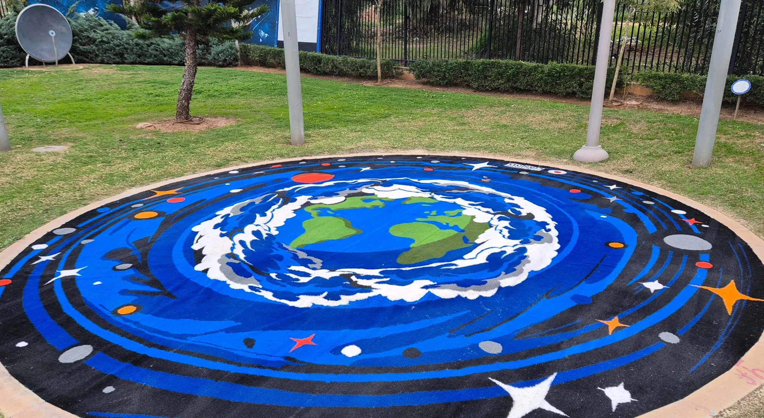 Circular Planet-Earth play surface ringed by orbiting planets and stars