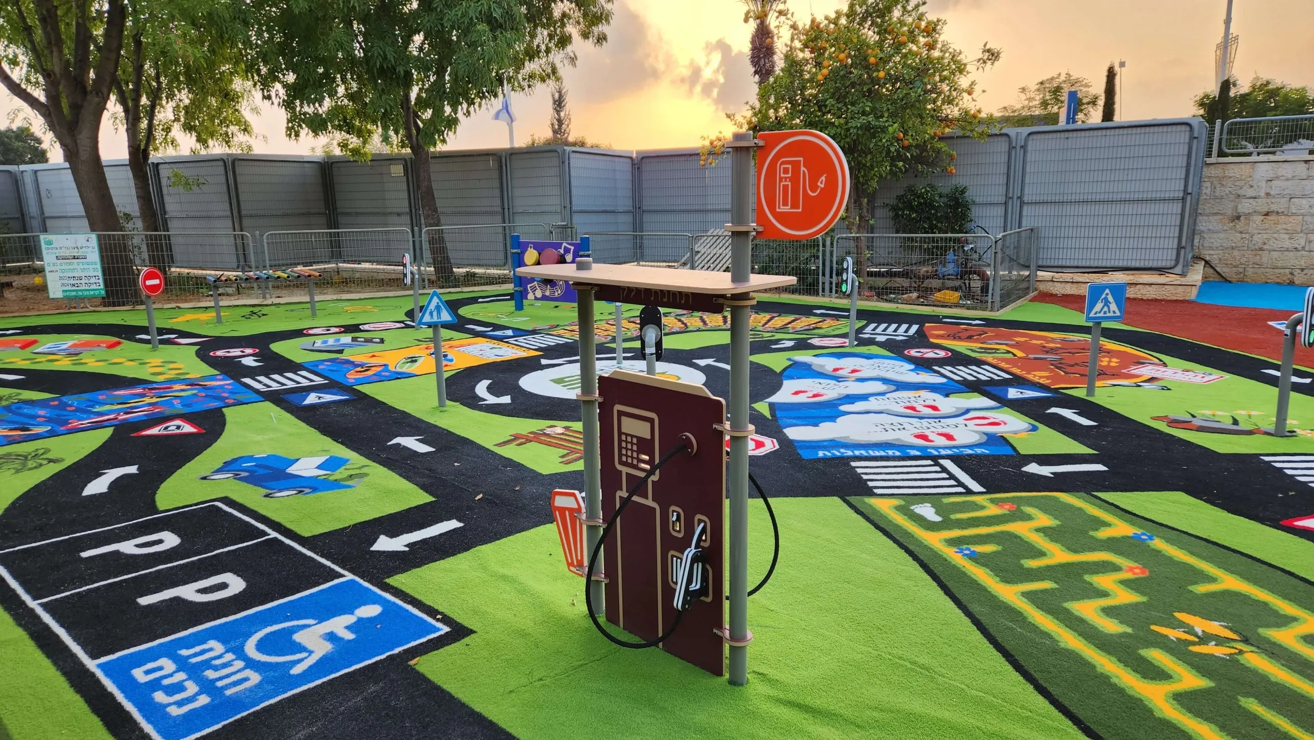 Road-safety traffic-town play surface with roads, signs and a fuel-pump prop