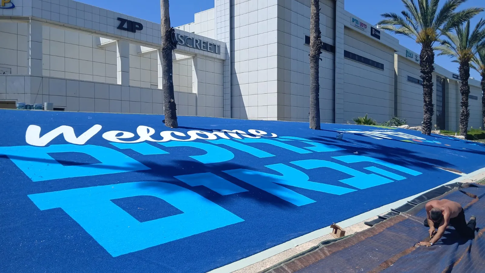 Large blue-and-white ColorPlay turf welcome sign